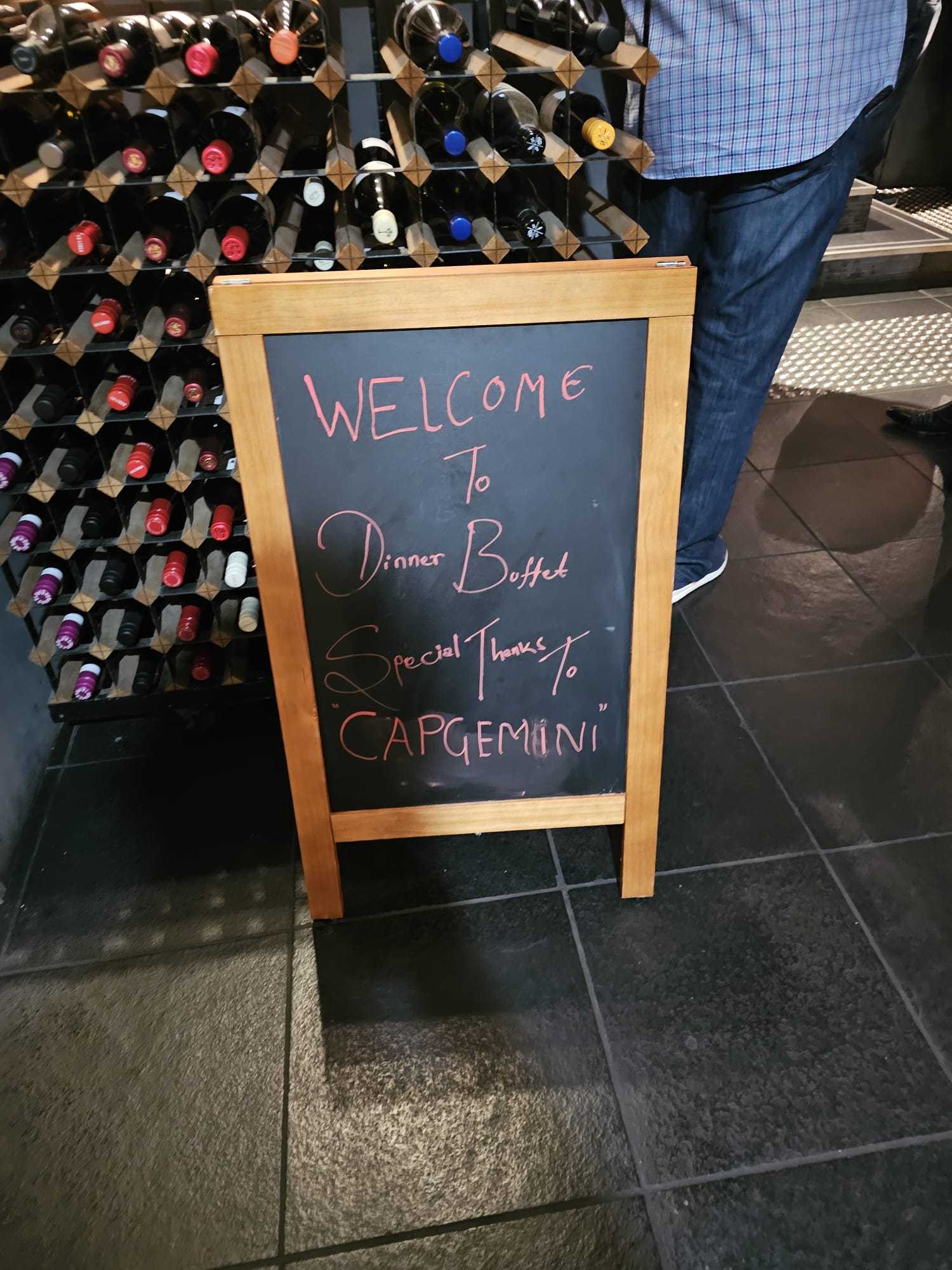 A chalkboard welcoming guests to a dinner buffet at Indian Mehek