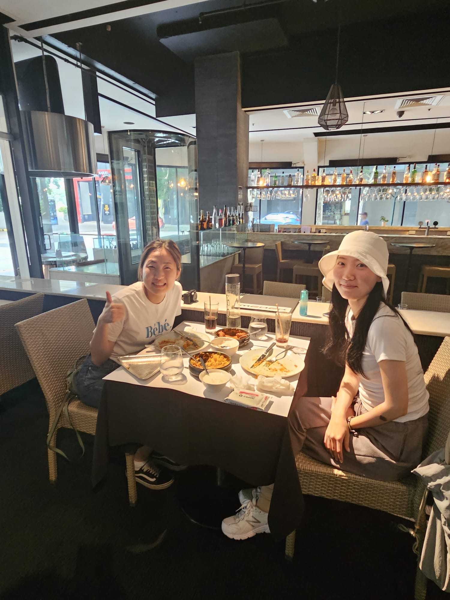 Two guests at a table after an Indian meal