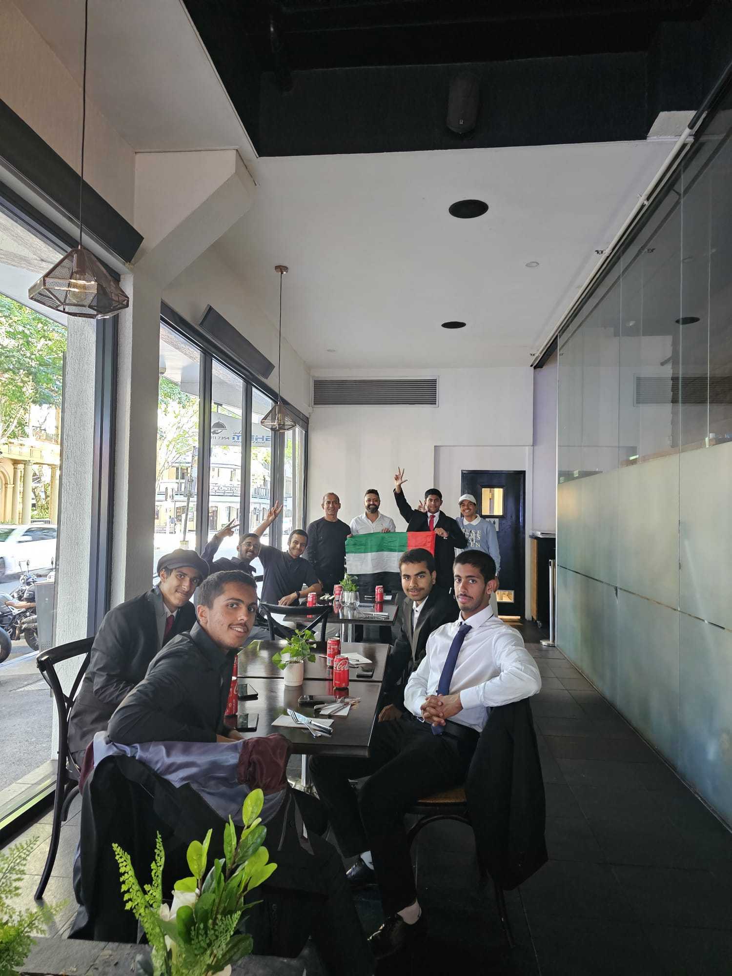 Guests seated at a window table in the Indian Mehek dining room